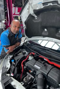 Krish working on a vehicle in the E&H Motors workshop